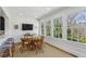 Bright breakfast nook with dining table, casual bar seating, and scenic backyard views at 435 Collier Nw Rd, Atlanta, GA 30309