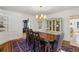 Inviting dining room featuring classic rug, wooden table set, bright light fixture, and a china cabinet at 435 Collier Nw Rd, Atlanta, GA 30309