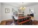 Bright dining room with hardwood floors, a wooden table with bench, and a vintage chandelier at 435 Collier Nw Rd, Atlanta, GA 30309