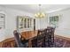 Bright dining room with hardwood floors, a wooden table with bench, and a vintage chandelier at 435 Collier Nw Rd, Atlanta, GA 30309