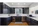 Elegant kitchen features dark cabinets, white countertops, stainless steel appliances, and ample storage at 435 Collier Nw Rd, Atlanta, GA 30309