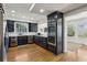 Modern kitchen with sleek, dark cabinetry, stainless steel appliances, and hardwood floors at 435 Collier Nw Rd, Atlanta, GA 30309