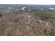 An aerial view captures the home nestled amongst the trees with its long driveway at 5060 Governors Walk Dr, Canton, GA 30115