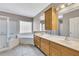 Bathroom featuring a double sink vanity, soaking tub and glass enclosed shower at 5060 Governors Walk Dr, Canton, GA 30115