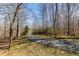 View of the long driveway leading to the home, surrounded by mature trees at 5060 Governors Walk Dr, Canton, GA 30115