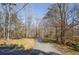 Long driveway leading to the home, surrounded by mature trees and landscaping at 5060 Governors Walk Dr, Canton, GA 30115