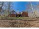 Back exterior view of home with multiple windows, deck, and yard with mature trees at 5060 Governors Walk Dr, Canton, GA 30115