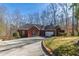 Charming red brick home with attached garage and a well-maintained, tree-lined front yard at 5060 Governors Walk Dr, Canton, GA 30115