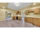 Open-concept kitchen featuring wooden cabinets, modern appliances, and laminate flooring at 5060 Governors Walk Dr, Canton, GA 30115