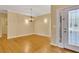 Bright living room featuring hardwood floors, crown molding, and a decorative chandelier at 5060 Governors Walk Dr, Canton, GA 30115