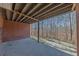 Back patio with brick support and wood support beams overlooking the tree-filled backyard at 5060 Governors Walk Dr, Canton, GA 30115