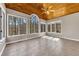 Bright sunroom featuring a vaulted wood ceiling, tiled flooring, and multiple windows with scenic views at 5060 Governors Walk Dr, Canton, GA 30115