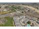 An aerial view showcases a well-planned community with manicured lawns near a golf course and surrounding mature trees at 5890 Vinyard Ln, Cumming, GA 30041