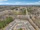 Scenic aerial shot of townhome community with green trees in the background at 5890 Vinyard Ln, Cumming, GA 30041