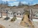 Aerial view showcasing multiple homes with garages and landscaped front yards at 5890 Vinyard Ln, Cumming, GA 30041