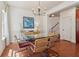 Charming dining room with a glass table and seating for six, featuring hardwood floors at 5890 Vinyard Ln, Cumming, GA 30041