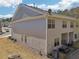 Back of home showing patio, siding and roof on a partly sunny day at 5890 Vinyard Ln, Cumming, GA 30041