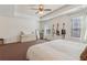 This is a spacious main bedroom featuring neutral walls, a ceiling fan, and large windows at 5890 Vinyard Ln, Cumming, GA 30041