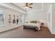 Spacious main bedroom with a tray ceiling, a ceiling fan, and two stylish guitars on the wall at 5890 Vinyard Ln, Cumming, GA 30041