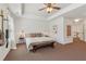 Large primary bedroom with a tray ceiling, ceiling fan, and an opening to the upstairs hallway at 5890 Vinyard Ln, Cumming, GA 30041