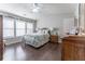 The bedroom features a tray ceiling, many windows, hardwood floors, and neutral paint colors at 946 Gardenia Curv, Canton, GA 30114