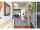 A welcoming foyer leads into an open-concept living space, enhanced by warm wood floors and soft lighting at 946 Gardenia Curv, Canton, GA 30114