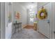 Bright foyer with neutral paint, wood floors, and an ornate wreath on the door creating an inviting entry at 946 Gardenia Curv, Canton, GA 30114