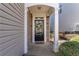 A welcoming front entrance features stone accents, white pillars, and a black front door adorned with a wreath at 946 Gardenia Curv, Canton, GA 30114