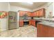 Well-lit kitchen features stainless steel appliances, wood cabinets, and unique tiled flooring at 946 Gardenia Curv, Canton, GA 30114