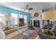 Bright living room with a fireplace, ceiling fan, colorful rug, and multiple seating options at 946 Gardenia Curv, Canton, GA 30114