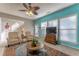 Bright living room with a ceiling fan, colorful rug, and large windows letting in natural light at 946 Gardenia Curv, Canton, GA 30114