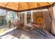 Cozy covered patio featuring a hanging chair and wicker seating, perfect for relaxing outdoors at 946 Gardenia Curv, Canton, GA 30114