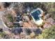 Aerial view of community featuring a playground, pool, parking, and mature trees, highlighting amenities at 2002 Stonewick Ct, Lawrenceville, GA 30043