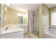 Bright bathroom featuring double sink vanity with modern fixtures and a glass-enclosed shower at 2002 Stonewick Ct, Lawrenceville, GA 30043