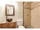 Bathroom featuring a walk-in shower with a tiled wall and a vessel sink with a granite counter at 2002 Stonewick Ct, Lawrenceville, GA 30043