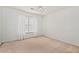 Bedroom featuring a window with blinds and neutral-colored carpet at 2002 Stonewick Ct, Lawrenceville, GA 30043