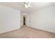 Spacious bedroom with neutral carpet, a ceiling fan, and a door to a bathroom at 2002 Stonewick Ct, Lawrenceville, GA 30043