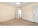 Bedroom with plush carpet, open door, and a ceiling fan for added comfort at 2002 Stonewick Ct, Lawrenceville, GA 30043