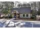 Charming clubhouse featuring stone pillars and well-manicured landscaping in a serene, wooded community at 2002 Stonewick Ct, Lawrenceville, GA 30043