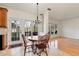 Charming dining area with a round wooden table, chandelier, and views of the outdoors through large windows at 2002 Stonewick Ct, Lawrenceville, GA 30043