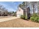 Side exterior view showing the driveway and attached two-car garage at 2002 Stonewick Ct, Lawrenceville, GA 30043