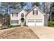 Charming two-story home featuring a well-manicured front yard and a two-car garage at 2002 Stonewick Ct, Lawrenceville, GA 30043