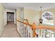 View of the upstairs hallway leading to bedrooms, featuring a staircase and pendant light at 2002 Stonewick Ct, Lawrenceville, GA 30043