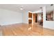 Open-concept living area with hardwood floors seamlessly transitions into a modern kitchen and dining space at 2002 Stonewick Ct, Lawrenceville, GA 30043