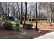 Community playground with a slide, swings, and a picnic table in a wooded area at 2002 Stonewick Ct, Lawrenceville, GA 30043