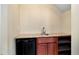 Basement wet bar area features granite countertops, wooden cabinets, and built-in mini fridge at 2002 Stonewick Ct, Lawrenceville, GA 30043