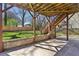 Backyard view with a ground level stone patio and staircase leading to the upper level deck at 2108 Main Nw St, Atlanta, GA 30318