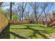 Spacious fenced backyard with lush green lawn and mature trees at 2108 Main Nw St, Atlanta, GA 30318
