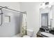 Bathroom showcasing tiled shower with rainfall fixture, built-in niche, and a granite vanity at 2108 Main Nw St, Atlanta, GA 30318