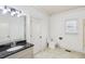 Clean bathroom features a large mirror, granite countertops, and a neutral color palette at 2108 Main Nw St, Atlanta, GA 30318